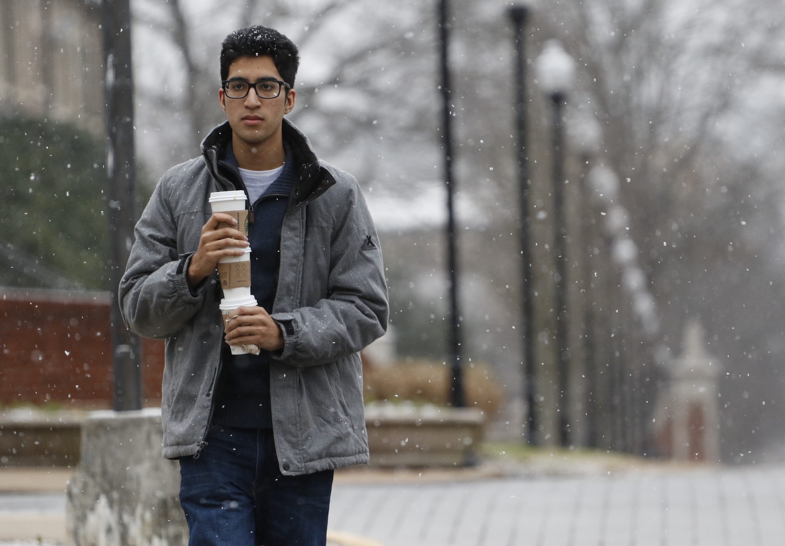 Staff Photo by Dan Henry / The Chattanooga Times Free Press- 2/9/16. Simar Singh makes a coffee run for his roommates as snow falls on the UTC campus in downtown Chattanooga on Tuesday, February 9, 2015.