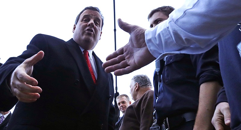 
              Republican presidential candidate, New Jersey Gov. Chris Christie shakes hands with firefighters while visiting a polling station on primary day during a campaign stop in Londonderry, N.H., Tuesday, Feb. 9, 2016. (AP Photo/Charles Krupa)
            