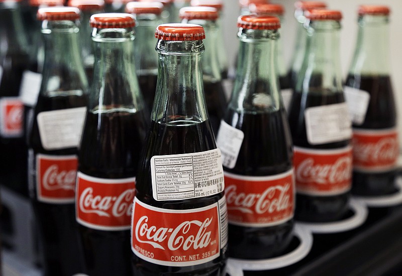 
              FILE - In this July 9, 2015, file photo, bottles of Coca-Cola are on display at a Haverhill, Mass., supermarket. On Tuesday, Feb. 9, 2016, Coca-Cola Co., reports financial results. (AP Photo/Elise Amendola, File)
            