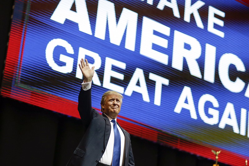 
              Republican presidential candidate, businessman Donald Trump waves has he arrives for a campaign rally Monday, Feb. 8, 2016, in Manchester, N.H. (AP Photo/David Goldman)
            