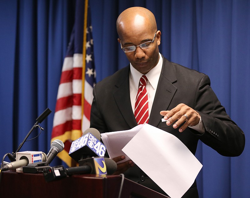 
              In this photo taken Thursday, Jan. 21, 2016, District Attorney Robert James reads through the charges after a grand jury indicted Officer Robert Olsen in the shooting death of Anthony Hill in Decatur, Ga. Police officers facing indictment in Georgia have a privilege that the average citizen doesn’t have and that even police don’t have in other states. Georgia law requires that a law enforcement officer be notified in advance that a grand jury will hear his or her case. The officer is also allowed to sit in on the entire proceeding and make a statement at the end that prosecutors can’t question. (Ben Gray/Atlanta Journal-Constitution via AP)
            