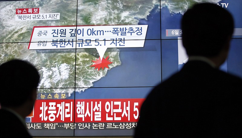 
              FILE - In this Wednesday, Jan. 6, 2016, file photo, people walk by a screen showing the news reporting about an earthquake near North Korea's nuclear facility, in Seoul, South Korea. South Korean officials detected an "artificial earthquake" near North Korea's main nuclear test site Wednesday, a strong indication that nuclear-armed Pyongyang had conducted its fourth atomic test.  (AP Photo/Lee Jin-man, File)
            