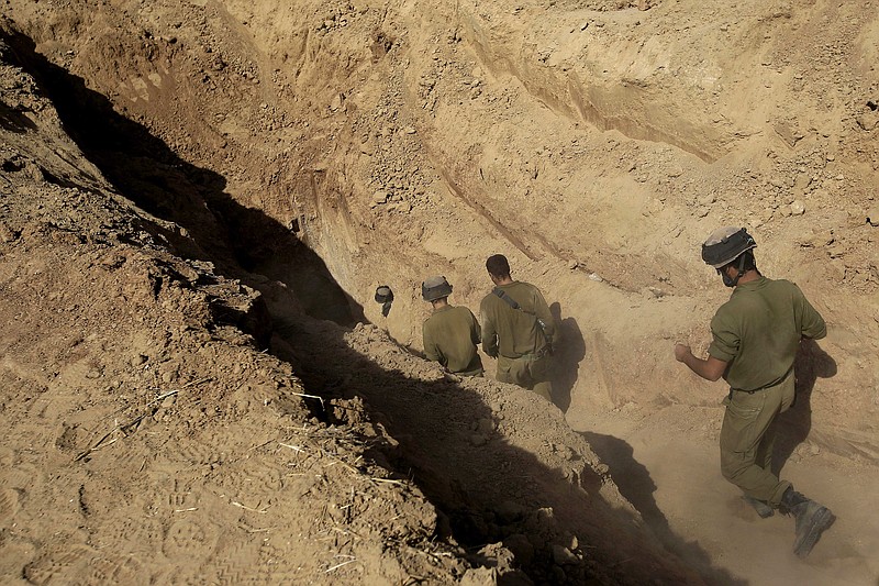 
              FILE - In this Sunday, Oct. 13, 2013 file photo, Israeli soldiers enter a tunnel discovered near the Israel Gaza border. Israel's military chief Lt. Gen. Gadi Eisenkot said Tuesday, Feb. 9, 2016, that Gaza's Hamas rulers have been rebuilding the sophisticated network of underground tunnels that Israel damaged during the 2014 war. Eisenkot said destroying this network is the military's top priority for 2016. (AP Photo/Tsafrir Abayov)
            