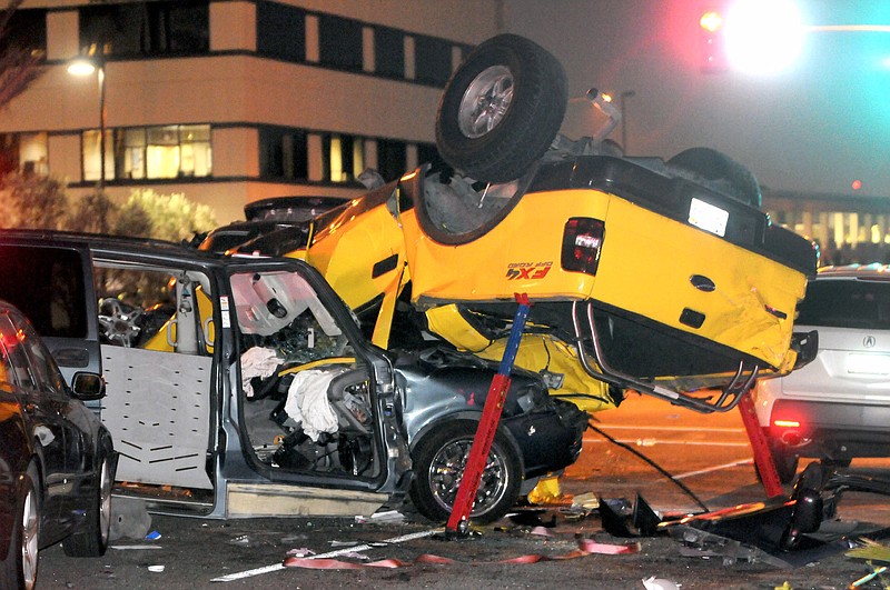 
              FILE - In this Oct. 10, 2013 file photo, a truck lies on top of a minivan at the site of a fatal eight vehicle accident in Fullerton, Calif. In a study by the Centers for Disease Control and Prevention released Tuesday, Feb. 9, 2016, guns, drugs and cars contribute substantially to the life-expectancy gap between the United States and other developed nations. (AP Photo/Richard Koehler)
            