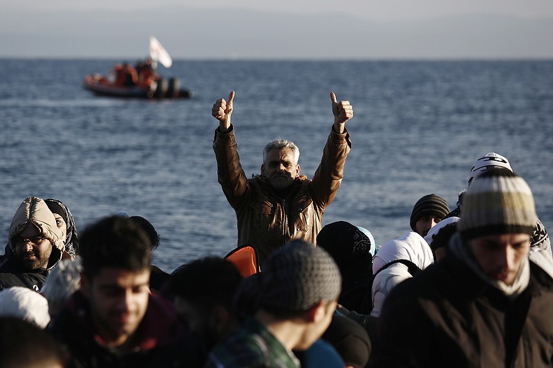 
              A man gestures after his arrival with other migrants and refugees on a dinghy from the Turkish coast to the northeastern Greek island of Lesbos, on Tuesday, Feb. 9 2016. The International Organization for Migration says Mediterranean crossings in the first six weeks of this year are running at nearly ten times the rate in the same period last year, and 409 people have died trying to cross this year. (AP Photo/Kostas Tsironis)
            