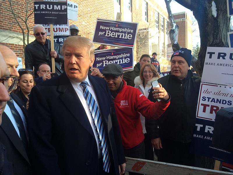 Donald Trumps greets voters at Webster Elementary School in Manchester, N.H., Tuesday, Feb. 9, 2016.