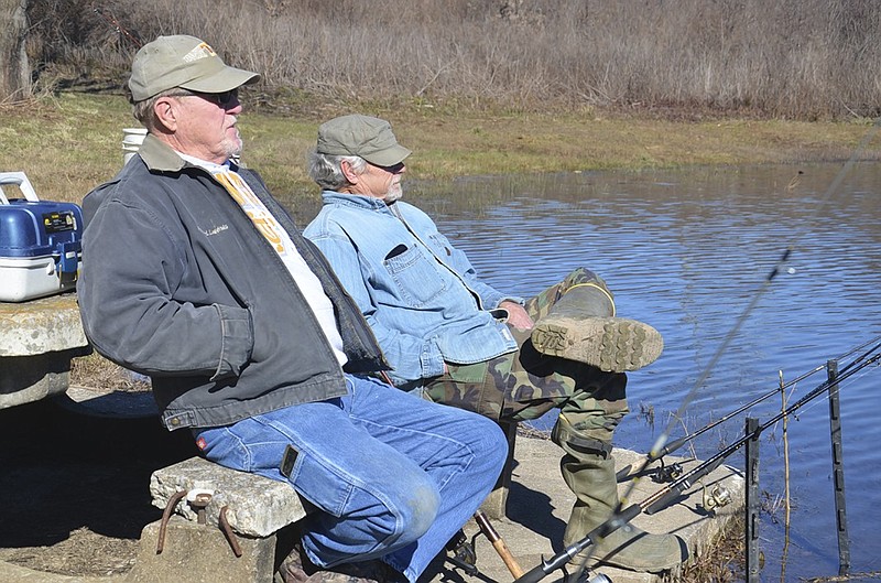 East Ridge residents Harold Skinner, left, and Terry Kilgore watch their fishing poles in hopes of a large TWRA-stocked trout taking the bait on Feb. 2 at Lake Junior. The two were not successful that day, but Kilgore returned the next morning and caught a limit of seven rainbow trout.