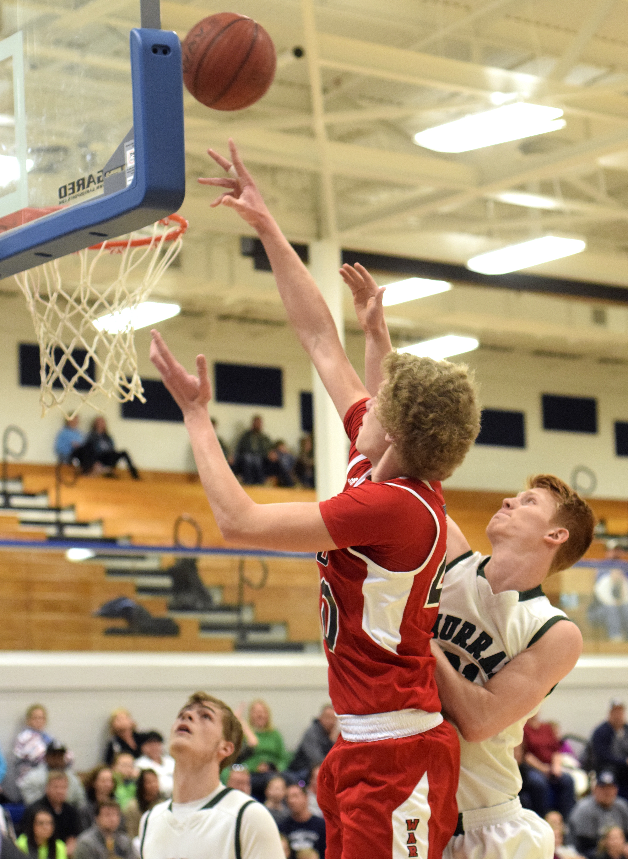 Lakeview's Triston Bennett (40) scores inside the defense of Murray County's Logan Bickford (21). The Lakeview-Fort Oglethrope Warriors faced the Murray County Indians in GHSA District 6-AAA basketball tournament at Ringgold High School, February 10, 2016.