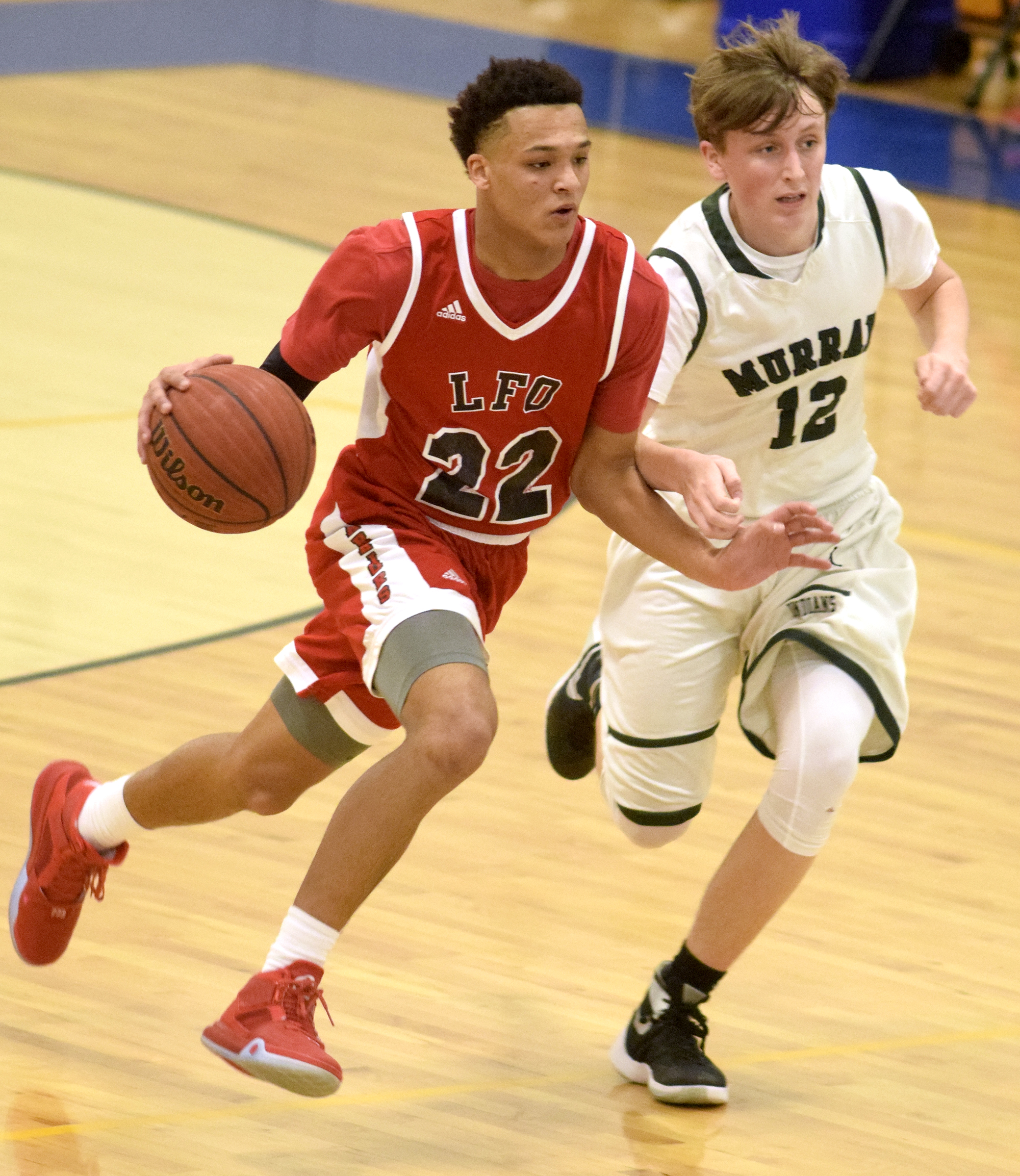 Lakeview Fort-Oglethorpe's Jordan Pickett (22) moves the ball upcourt as Murray County's Hunter Ary (12) defends during a Region 6-AAA tournament game Wednesday in Ringgold.