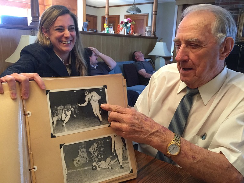 Former Bradley County Clerk Claude Climer looks at a high school scrapbook with his granddaughter Lindsay Arnold.