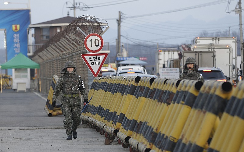 
              South Korean amy soldiers walk on Unification Bridge, which leads to the demilitarized zone, near the border village of Panmunjom in Paju, South Korea, Thursday, Feb. 11, 2016. South Korea said Wednesday that it will shut down a joint industrial park with North Korea in response to its recent rocket launch, accusing the North of using hard currency from the park to develop its nuclear and missile programs. (AP Photo/Ahn Young-joon)
            