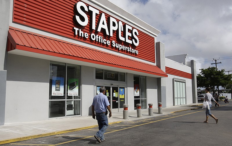 
              FILE - In this Nov. 15, 2011, file photo, people walk into a Staples office supply store in Miami. Staples has received European approval Wednesday, Feb. 10, 2016, for its buyout of Office Depot and in exchange, will split off businesses there to allay monopoly fears. (AP Photo/ Lynne Sladky, File)
            