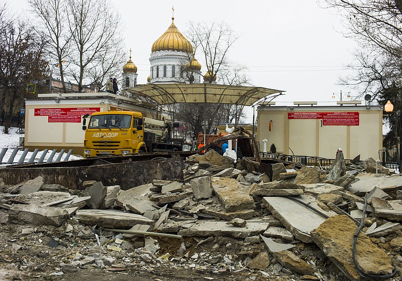 
              Ruins of flattened kiosks seen with the Christ the Saviour Cathedral at the background in downtown Moscow, Wednesday, Feb. 10, 2016. About half of Moscow's 104 kiosks, which sell items ranging from pastries and flowers to trinkets and kebabs, were flattened Monday evening. The city decided to tear them down in December, and the remaining ones will be torn down by Feb. 24, according to the Russian RIA Novosti news agency. It's unclear what will be put in their place. (AP Photo/Alexander Zemlianichenko)
            