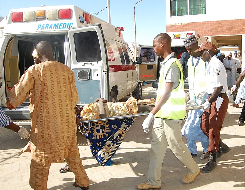 
              Rescue workers transport a victim of a suicide bomb attack at a refugee for treatment at a hospital, in  Maiduguri, Nigeria, Wednesday, Feb. 10, 2016. Two female suicide bombers blew themselves up in a northeast Nigerian refugee camp, killing at least 56 people, health and rescue officials said Wednesday. (AP Photo/Jossy Ola)
            