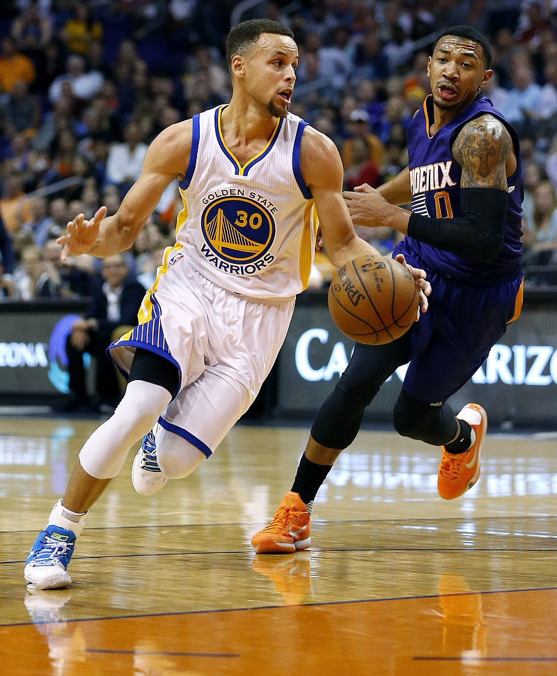 
              Golden State Warriors' Stephen Curry (30) drives past Phoenix Suns' Orlando Johnson during the first half of an NBA basketball game Wednesday, Feb. 10, 2016, in Phoenix. (AP Photo/Matt York)
            