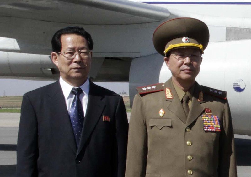 
              FILE - In this May 22, 2013 file photo, Kim Hyong Jun, deputy minister Foreign Affairs, Ri Yong Gil,  col. gen. of the Korean People's Army, pose before leaving Pyongyang Airport in North Korea for China.  South Korea says North Korean leader Kim Jong Un had his military chief executed for corruption. If true, the execution of Ri Yong Gil would be the latest in a series of killings, purges and dismissals since Kim took power in late 2011. (AP Photo/Kim Kwang Hyon, File)
            
