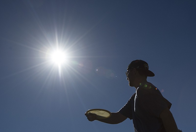 
              Ian Kellam, of Costa Mesa, fires a shot as he and friends play Disc Golf at a course in Central Park in Huntington Beach, Calif. on Tuesday, Feb. 9, 2016. A midwinter heat wave baked Southern California again Tuesday, breaking more February records as temperatures soared into the 80s and 90s even as the Santa Ana winds that stoked the atmosphere began to fade. (Ed Crisostomo/The Orange County Register via AP)  MAGS OUT; LOS ANGELES TIMES OUT; MANDATORY CREDIT
            