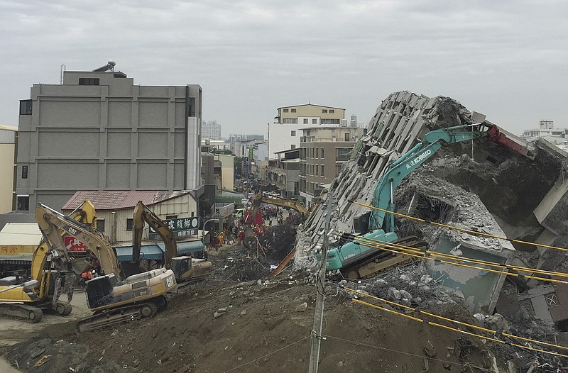 Rescue workers using excavators continue to search the rubble of a collapsed building complex in Tainan, Taiwan, Wednesday, Feb. 10, 2016.