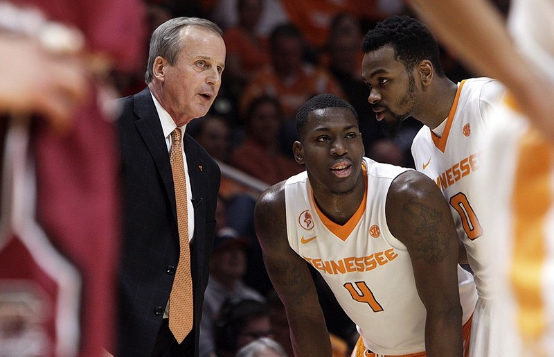 Tennessee basketball coach Rick Barnes talks with forward Armani Moore (4) and guard Kevin Punter during last month's win over South Carolina in Knoxville. Like most SEC teams this season, the Vols have enjoyed much more league success at home than on the road.