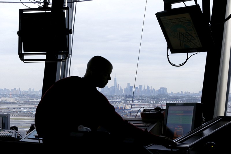 
              FILE - In this May 21, 2015, file photo an air traffic controller works in the tower at Newark Liberty International Airport in Newark, N.J. A Republican-controlled House committee on Feb. 11, 2016, endorsed a bill that would wrest responsibility for running the nation's air traffic control system from the government and turn it over to a private, nonprofit corporation run by airlines and other aviation interests. (AP Photo/Julio Cortez, File)
            