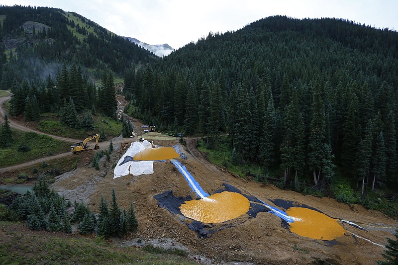 
              FILE - In this Aug. 12, 2015 file photo, water flows through a series of retention ponds built to contain and filter out heavy metals and chemicals from the Gold King mine chemical accident, in the spillway about 1/4 mile downstream from the mine, outside Silverton, Colo. A U.S. House probe of the mine waste accident in Colorado that fouled rivers in three states with arsenic, lead and other toxic substances has found further evidence that EPA workers knew a spill from the gold mine was possible, according to documents released Thursday, Feb. 11, 2016 by a U.S. House committee.  (AP Photo/Brennan Linsley, file)
            