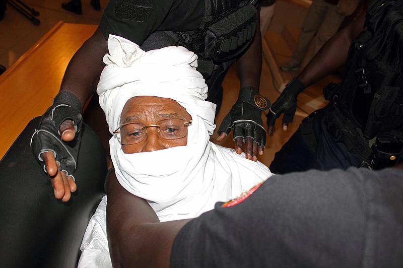
              FILE- In this Monday July. 20, 2015 file photo security personnel surround former Chadian dictator Hissene Habre inside the court in Dakar, Senegal. The lawyers for Chad’s ex-dictator Hissene Habre argued Thursday, Feb. 11, 2016,  against the credibility of testimonies and reports that place direct blame on the leader for the deaths of thousands during his rule, as the prosecution seeks a life sentence. (AP Photo/Ibrahima Ndiaye, File)
            