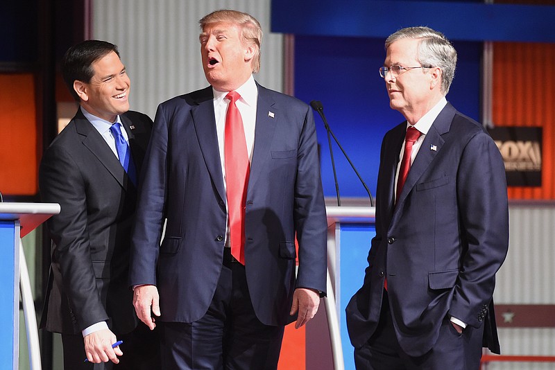 Republican presidential candidate, businessman Donald Trump, center, Republican presidential candidate, Sen. Marco Rubio, R-Fla., left, and Republican presidential candidate, former Florida Gov. Jeb Bush speak at a break during the Fox Business Network Republican presidential debate at the North Charleston Coliseum, Thursday, Jan. 14, 2016, in North Charleston, S.C.
