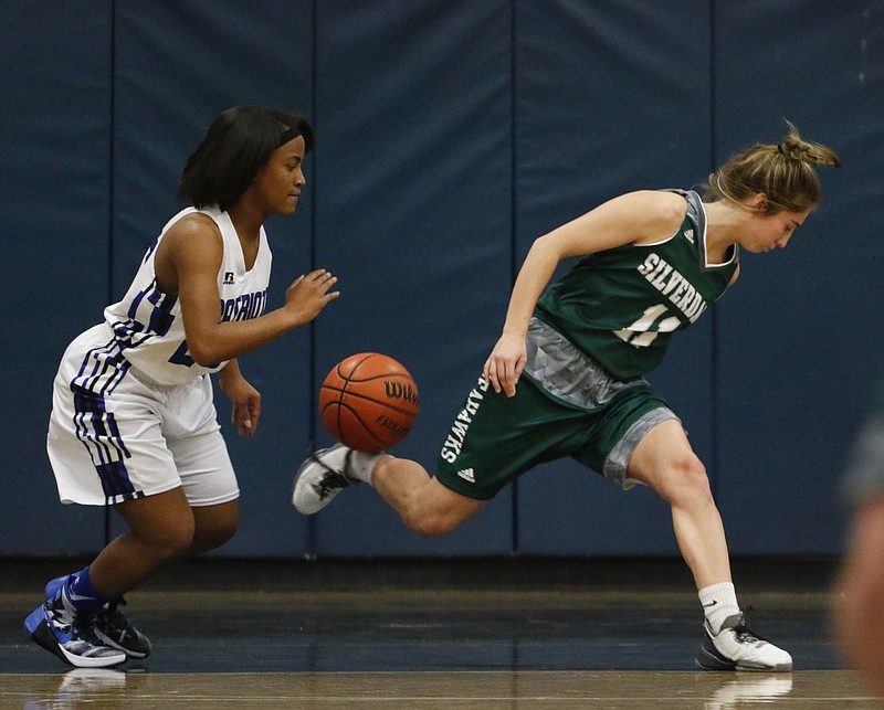 Staff Photo by Dan Henry / The Chattanooga Times Free Press- 2/12/16. Chattanooga School for the Arts and Sciences' Sheridan Randolph (25) steals the ball from Silverdale Baptist's Emily Harkleroad (11) during their matchup at the Lady Patriot's home court on Friday, February 12, 2016. Arts and Sciences won over Silverdale with a final score of 49-44. 