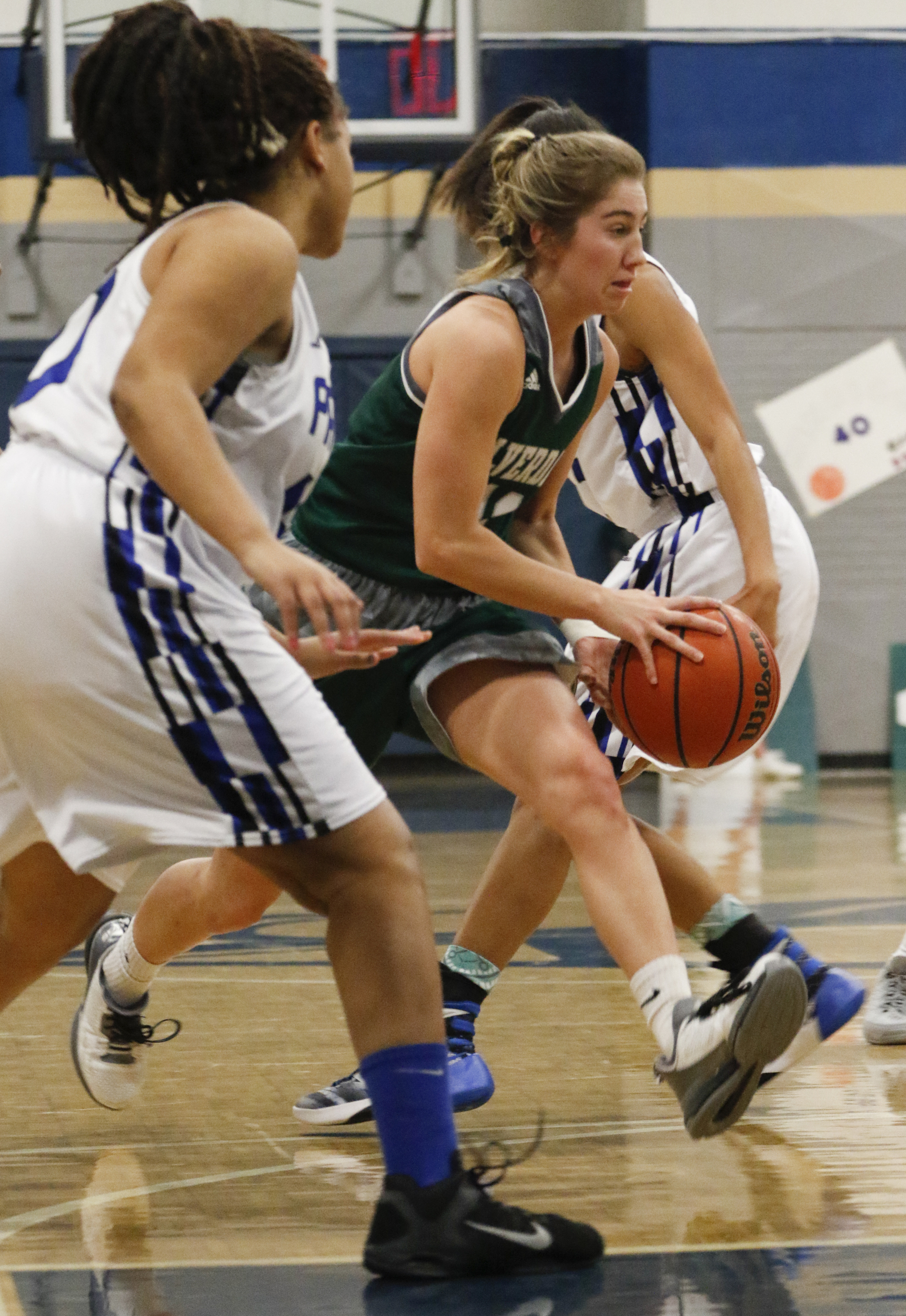 Staff Photo by Dan Henry / The Chattanooga Times Free Press- 2/12/16. Chattanooga School for the Arts and Sciences' defenders close in as Silverdale Baptist's Emily Harkleroad (11) drives to the basket during their matchup at the Lady Patriot's home court on Friday, February 12, 2016. Arts and Sciences won over Silverdale with a final score of 49-44.