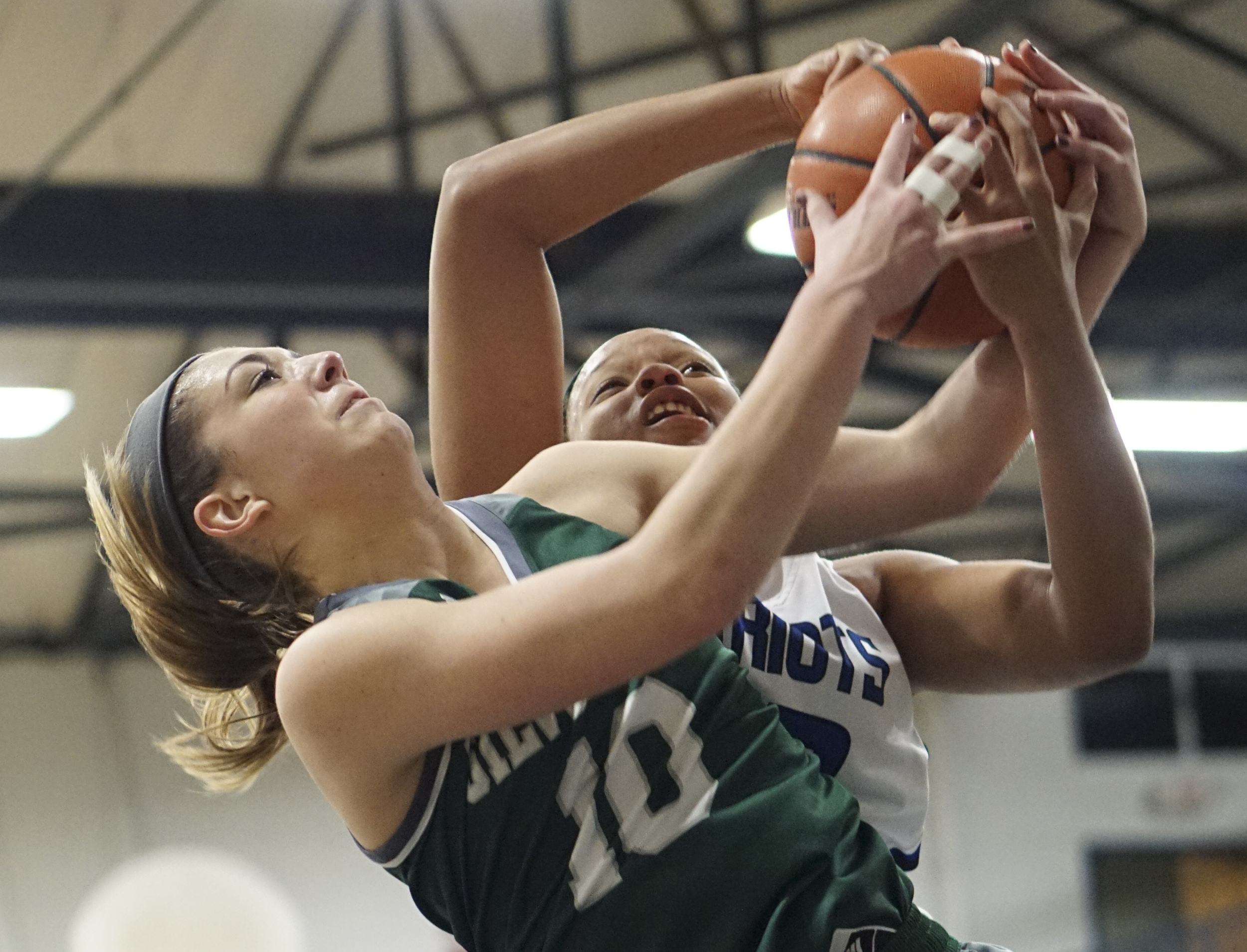 Staff Photo by Dan Henry / The Chattanooga Times Free Press- 2/12/16. Chattanooga School for the Arts and Sciences' Crystal Ealey (42) and Silverdale Baptist's Emily Skelton (10) battle for a rebound during their matchup at the Lady Patriot's home court on Friday, February 12, 2016. Arts and Sciences won over Silverdale with a final score of 49-44.