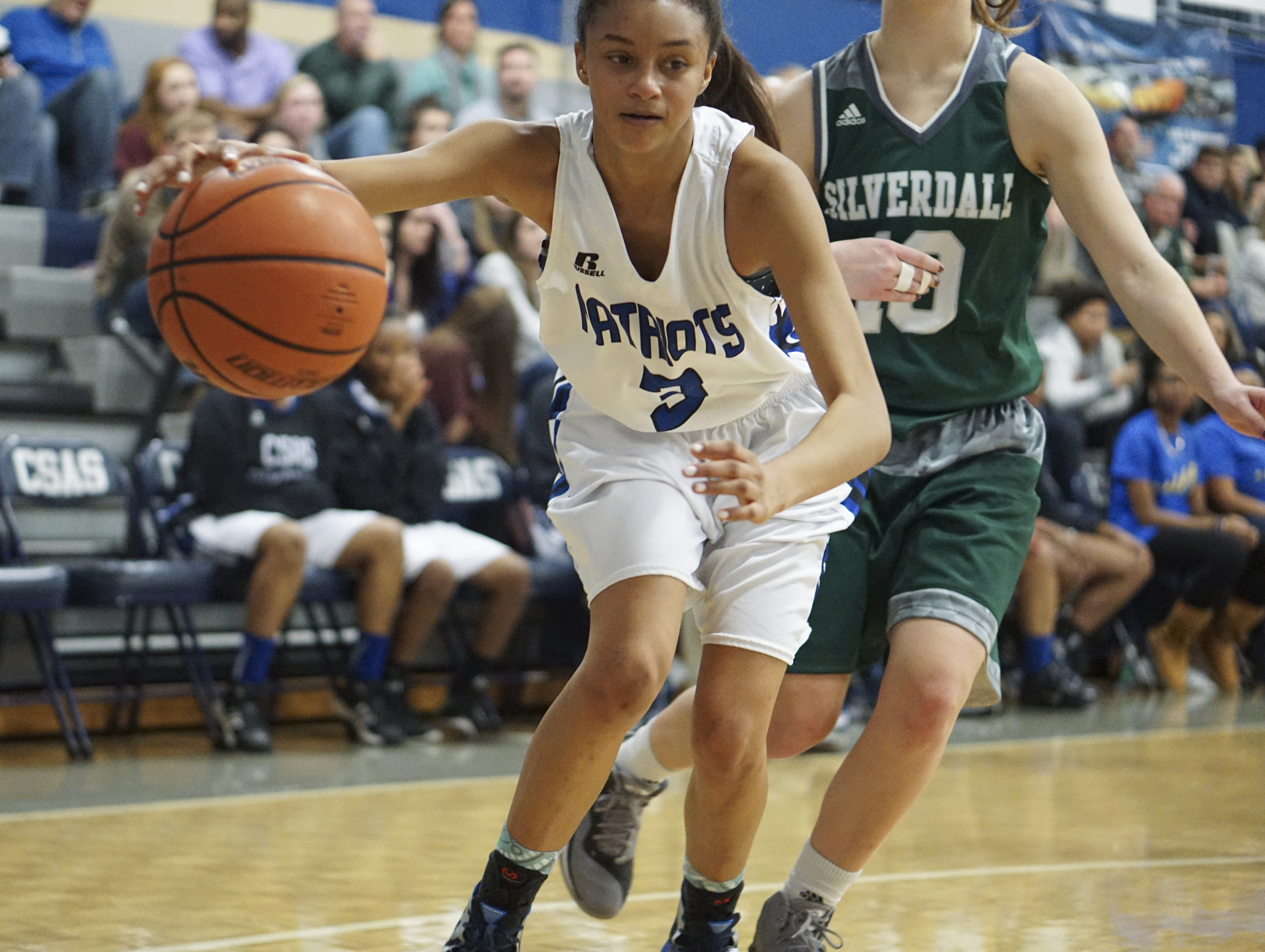 Staff Photo by Dan Henry / The Chattanooga Times Free Press- 2/12/16. Chattanooga School for the Arts and Sciences' Aizha Little (3) makes her way past Silverdale Baptist's Emily Skelton (10) during their matchup at the Lady Patriot's home court on Friday, February 12, 2016. Arts and Sciences won over Silverdale with a final score of 49-44.