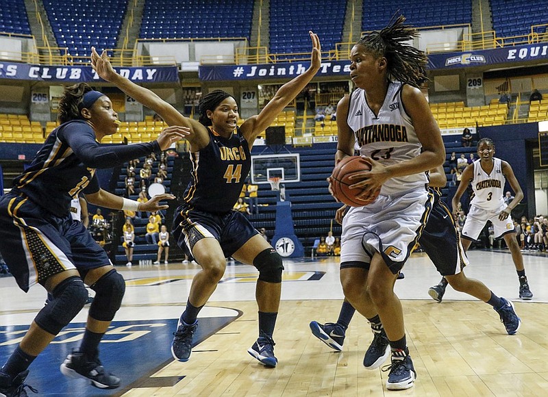 UTC guard Moses Johnson, right, tries to break around UNCG center Mariah Wilson (44) and guard Lucy Mason during the Mocs' home basketball game against UNC-Greensboro at McKenzie Arena on Saturday, Jan. 16, 2016, in Chattanooga, Tenn.