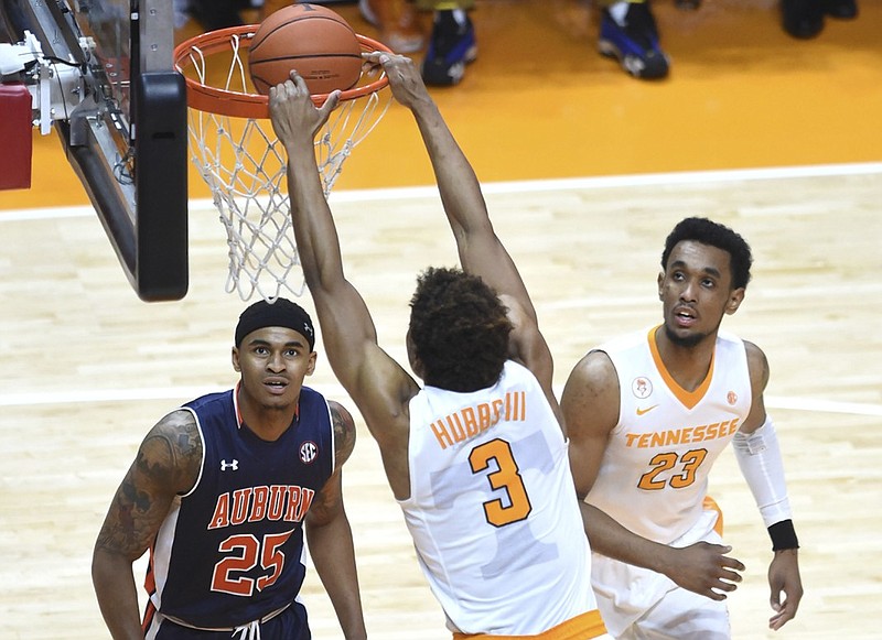 Tennessee guard Robert Hubbs III (3) dunks the ball as Auburn forward Jordon Granger (25) and Auburn guard TJ Lang (23) look on during the second half of an NCAA basketball game in Knoxville, Tenn., Tuesday, Feb. 9, 2016. Tennessee won, 71-45. (Adam Lau/Knoxville News Sentinel via AP) MANDATORY CREDIT