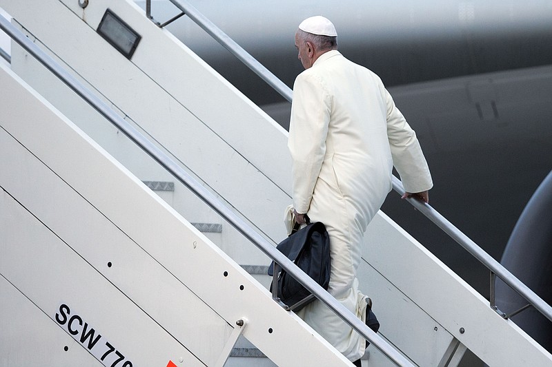 
              Pope Francis boards an airplane at Rome's Fiumicino airport on his way to a week-long trip to Mexico, Friday, Feb. 12, 2016. The pontiff is scheduled to stop in Cuba for an historical meeting with Russian Orthodox Patriarch Kirill that the Vatican sees as a historic step in the path toward healing the 1,000-year schism that split Christianity. (AP Photo/Andrew Medichini)
            