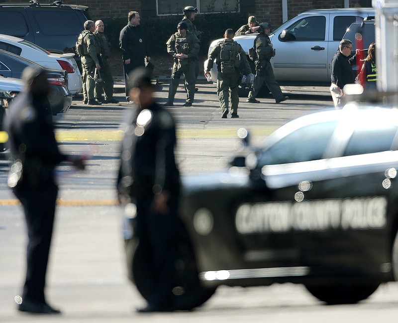 
              Police officers mill around the parking lot of the Villages on the River apartment complex on Thursday, Feb. 11, 2016, following a fatal police shooting, in Riverdale, Ga. (John Spink/Atlanta Joutal police shooting, rnal-Constitution via AP)  MARIETTA DAILY OUT; GWINNETT DAILY POST OUT; LOCAL TELEVISION OUT; WXIA-TV OUT; WGCL-TV OUT; MANDATORY CREDIT
            