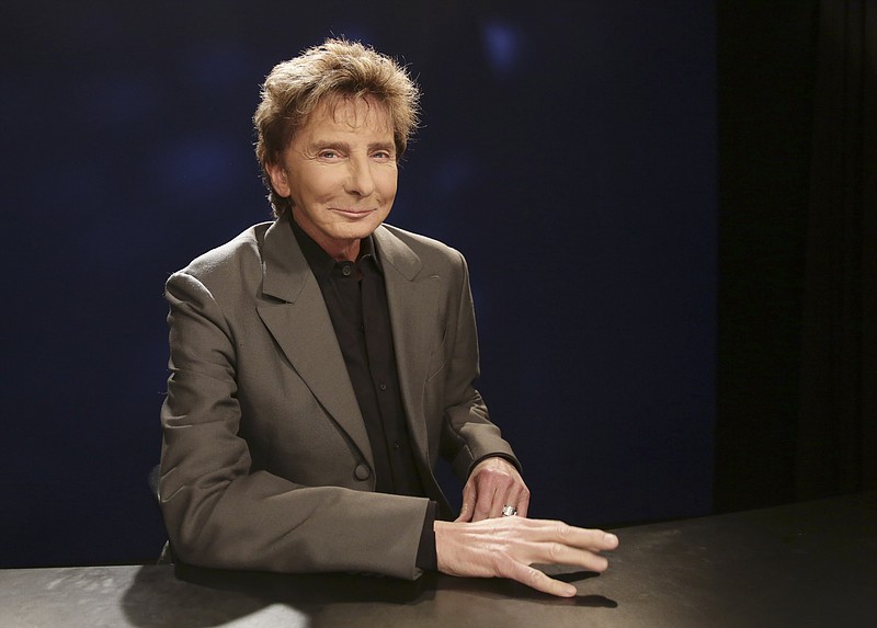 
              FILE - In this Oct. 27, 2014 file photo, singer-songwriter and producer Barry Manilow poses for a photograph during an interview in New York. Manilow has been forced to postpone two concerts following a rough week of oral surgery. Manilow had surgery twice earlier this week, and still managed to make a concert in Memphis on Wednesday. But after that, he was brought back to Los Angeles for surgery Friday when complications developed. (AP Photo/Kathy Willens, File)
            