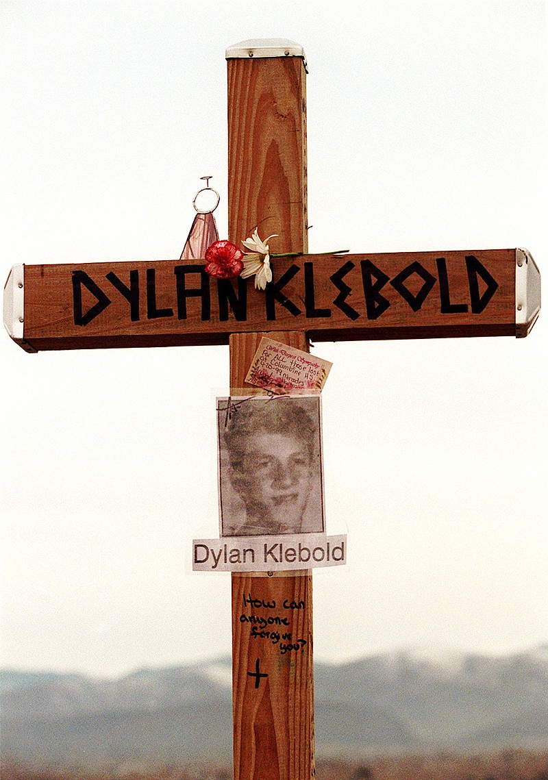 
              FILE - This April 28, 1999 file photo shows a cross bearing the name and likeness of Dylan Klebold and a message "How can anyone forgive you?" on a hill in Littleton, Colo., near Columbine High School where someone erected crosses to honor the dead. Klebold, along with schoolmate Eric Harris, killed 13 people before taking their own lives on April 20, 1999. In an interview with ABC News' Diane Sawyer set to air on "20/20" late Friday, Feb. 12, 2016, Sue Klebold, Dylan's mother, says she didn't know anything was wrong with her son before the attack, and that she thinks about the victims and their families every day.(Eric Strachan/Denver Rocky Mountain News via AP, File)
            