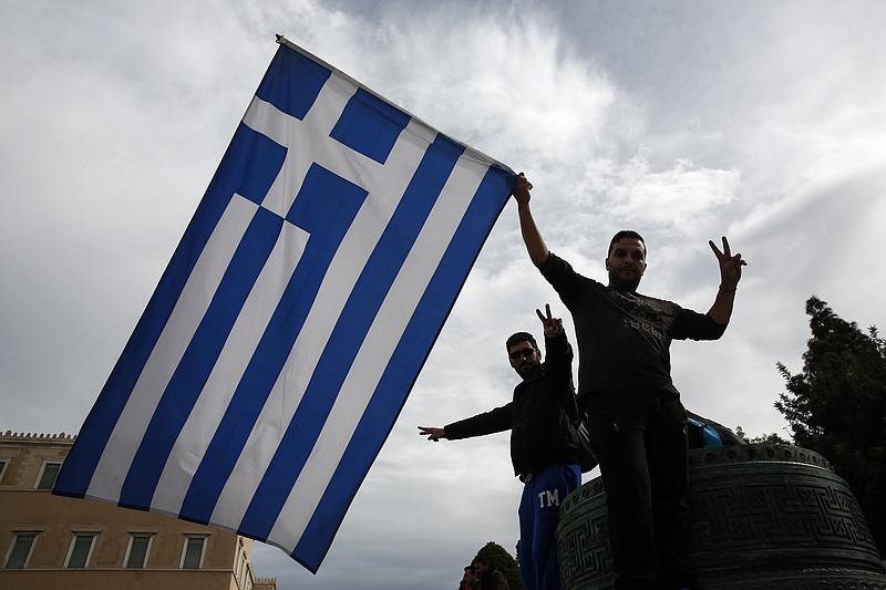 
              Farmers wave a Greek flag during an anti-government rally in front of the parliament in Athens, on Saturday, Feb. 13, 2016. Farmers from across Greece gather in Athens for a two-day protest against the government and its plans to impose new tax hikes and pension charges. Bailout lenders are demanding that Greece scrap tax breaks for farmers and impose pension reforms that will lead to higher monthly contributions from the self employed and salaried employees. (AP Photo/Yorgos Karahalis)
            