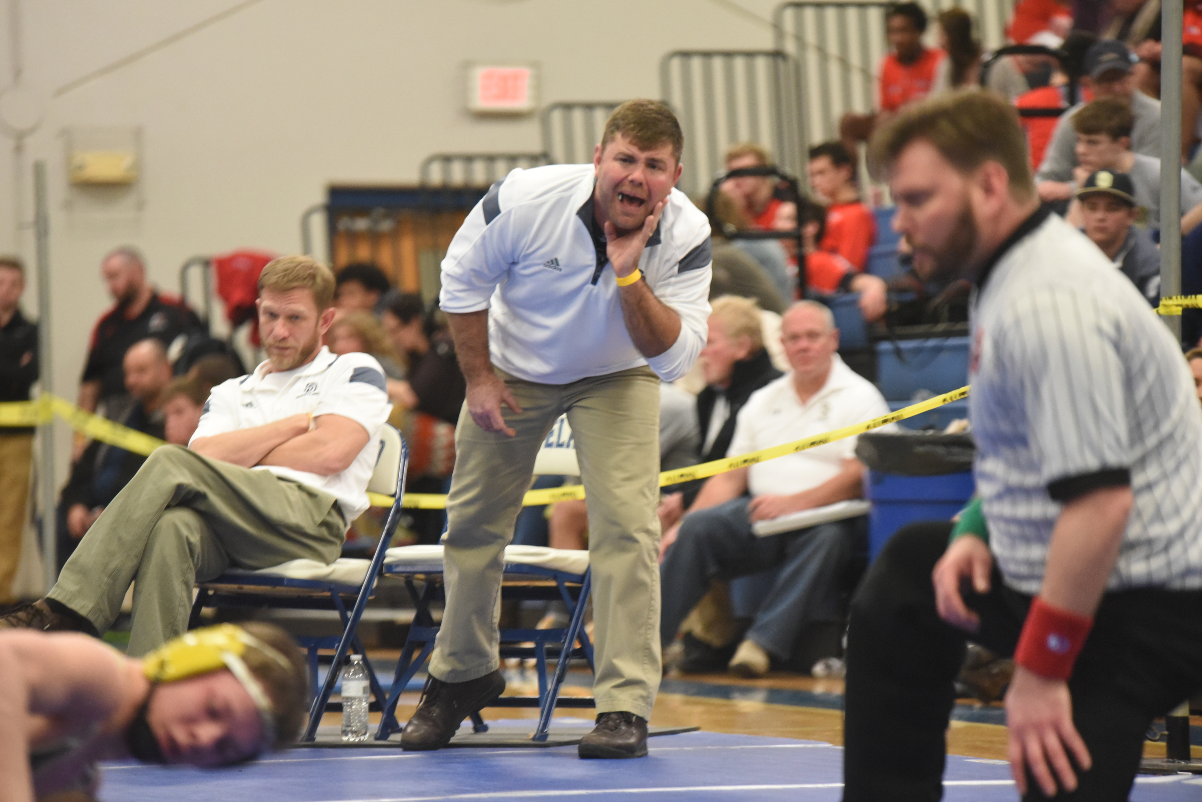Soddy-Daisy wrestling coach Jim Higgins yells instruction to one of his wrestlers during Saturday's Region 4-AAA wrestling tournament held at Cleveland Middle School.