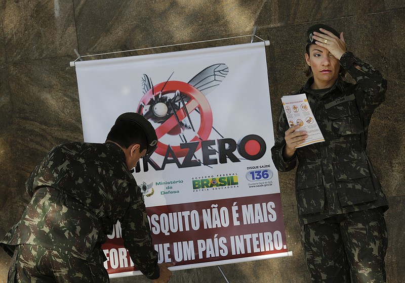 
              Army soldiers set a banner that reads in Portuguese "A mosquito is not stronger than a whole country" at the Central station, in Rio de Janeiro, Brazil, Saturday, Feb. 13, 2016. More than 200,000 army, navy and air force troops are fanning out across Brazil to show people how to eliminate the Aedes aegypti mosquito that spreads the Zika virus, which many health officials believe is linked to severe birth defects. The nationwide offensive is part of President Dilma Rousseff's declared war on the virus that has quickly spread across the Americas. (AP Photo/Silvia Izquierdo)
            