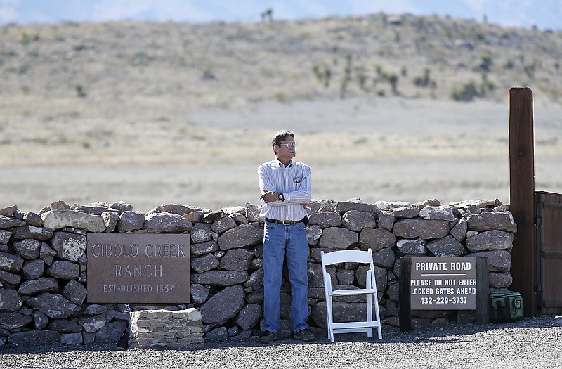 
              A man guards the entrance to Cibolo Creek Ranch Saturday, Feb. 13, 2016, on U.S. 67 near Shafter, Texas.  Supreme Court Justice Antonin Scalia was found dead Saturday morning at the private residence in the Big Bend area of West Texas, after he'd gone to his room the night before and did not appear for breakfast, said Donna Sellers, speaking for the U.S. Marshals Service in Washington. He was 79. (Edward A. Ornelas/The San Antonio Express-News via AP) MAGS OUT, NO SALES, SAN ANOTNIO OUT, AP MEMBERS ONLY, MANDATORY CREDIT, EFE OUT, ONLINE OUT
            