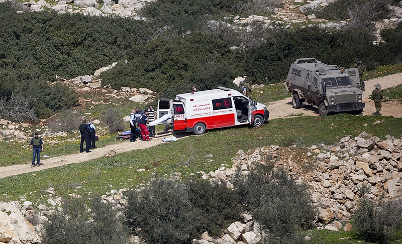 
              Palestinian medics load bodies of two Palestinians near the village of Aeraqh near the West Bank city of Jenin, Sunday, Feb. 14, 2016. The two Palestinians were throwing rocks at passing vehicles near the West Bank city of Jenin, and when forces arrived at the scene, one of the Palestinians opened fire at them, soldiers fired back and killed the two Palestinians, Israeli army said. (AP Photo/Majdi Mohammed)
            