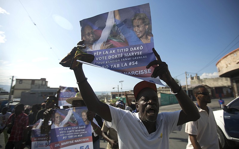 
              A demonstrator chants in favor of Senate President Jocelerme Privert during a march in Port-au-Prince, Haiti, Saturday, Feb. 13, 2016. Supporters of Bertrand-Aristide's Lavalas political party rallied for Privert to fill the void left by twice postponed presidential and legislative runoff elections and the departure of President Michel Martelly. An interim government will rule until an elected leader can take office May 14, and for now Prime Minister Evans Paul remains in office. (AP Photo/Dieu Nalio Chery)
            