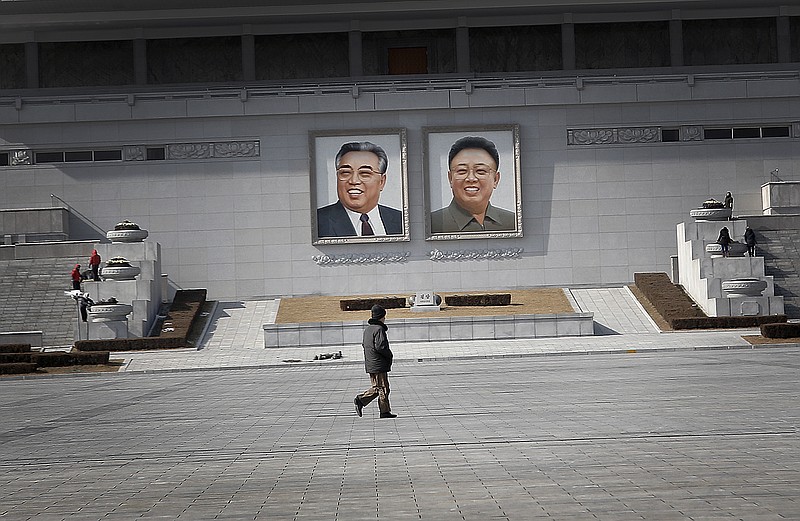 
              A man walks past portraits of the late North Korean leaders Kim Il Sung and Kim Jong Il, at the Kim Il Sung Square on Sunday, Feb. 14, 2016, in Pyongyang, North Korea. North Korea launched a rocket Feb. 7, carrying what it said was an Earth observation satellite into space. The U.N. Security Council condemned North Korea's launch of a long-range rocket that world leaders called a banned test of ballistic missile technology and another "intolerable provocation." The U.N.'s most powerful body pledged to quickly adopt a new resolution with "significant" new sanctions. (AP Photo/Wong Maye-E)
            