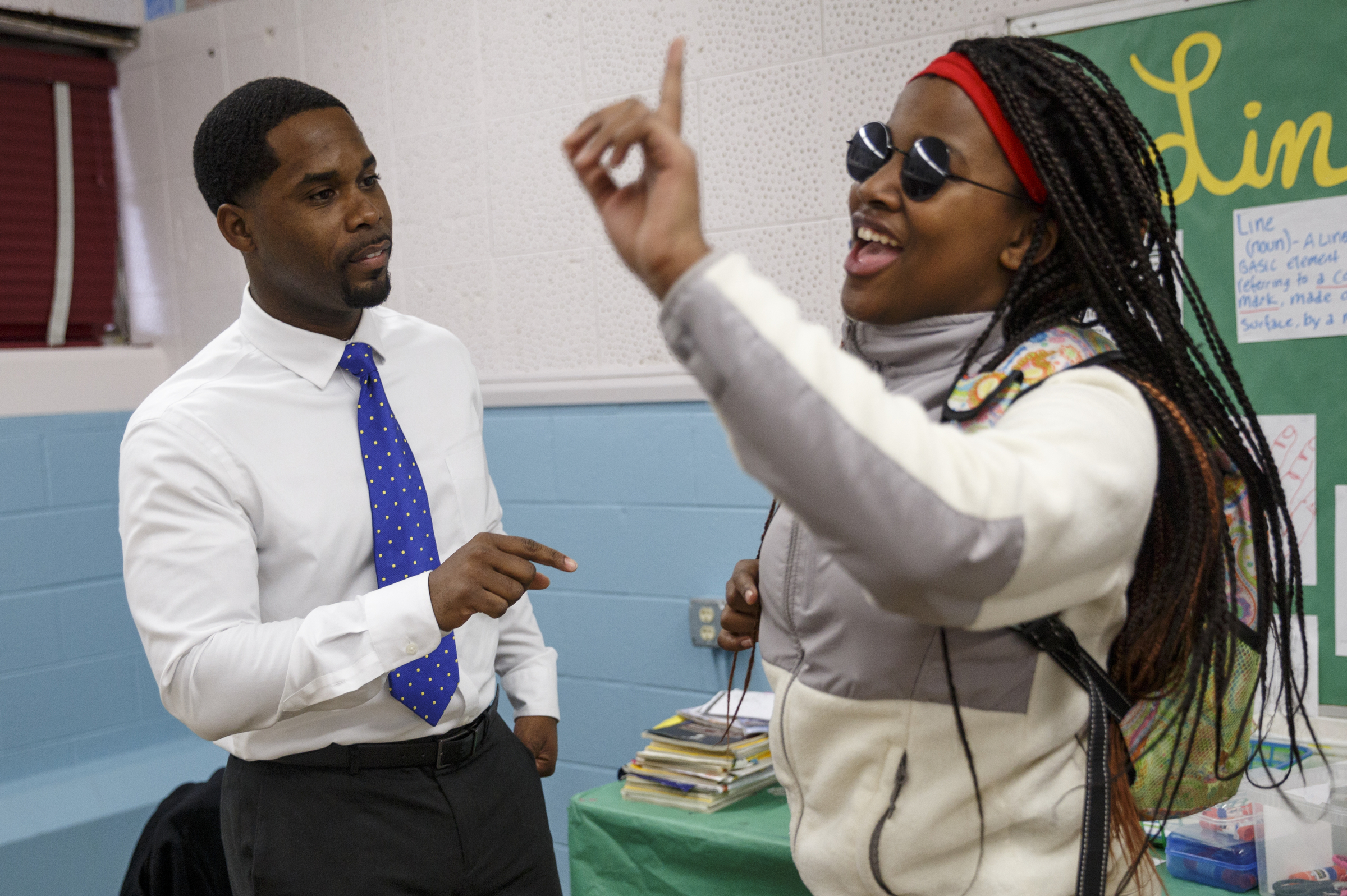 Marcellus Barnes helps Asia Johnson practice their class mission statement before leading students in a choir lesson at Orchard Knob Middle School on Tuesday, Feb. 16, 2016, in Chattanooga, Tenn. Barnes is hosting his 10th annual Sounds of Unity concert in recognition of Black History Month at Abbas House on Feb. 27.