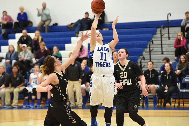Ringgold's Bethany Hedrick (11) takes an inside the lane shot over East Hall defenders in the first round Class 3-AAA state basketball tournament Tuesday night.