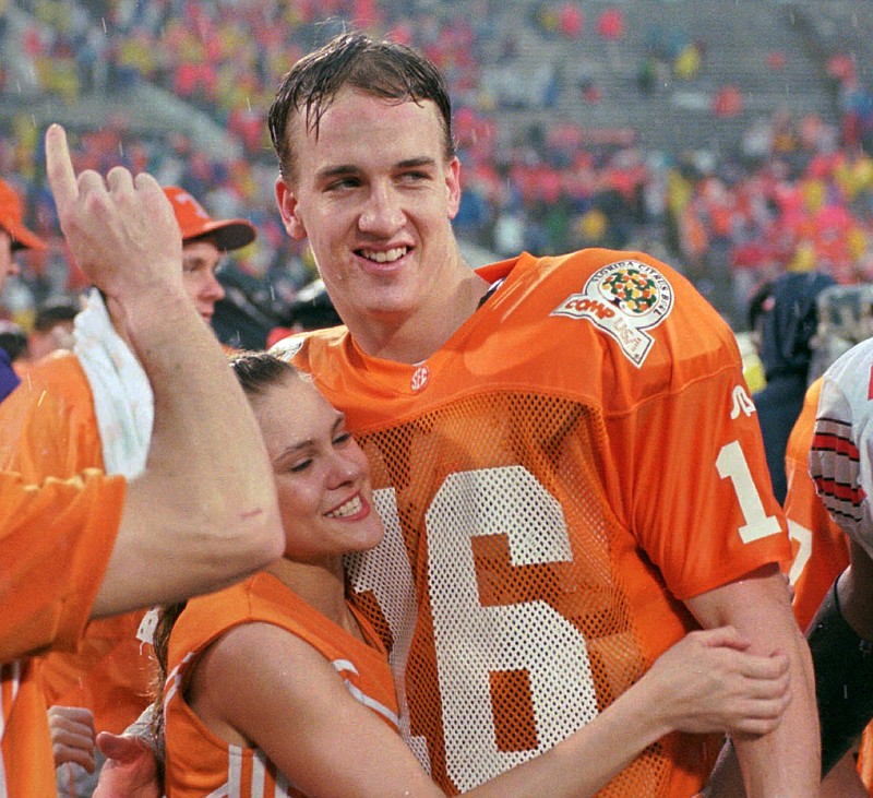 In this Jan. 1, 1996, file photo, Tennessee quarterback Peyton Manning (16) is congratulated by an unidentified cheerleader after Tennessee defeated Ohio State 20-14 to win the Citrus Bowl, in Orlando. The lawyer for six women suing the University of Tennessee on its handling of sexual assault complaints by student-athletes is focused on the school's systemic problems he believes exist and is surprised at the attention the complaint's brief mention of Peyton Manning generated.