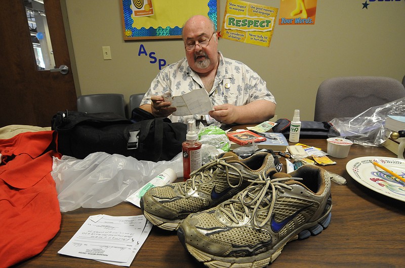 Brother Ron Fender looks through belongings at the Community Kitchen, where he worked, in August 2011.