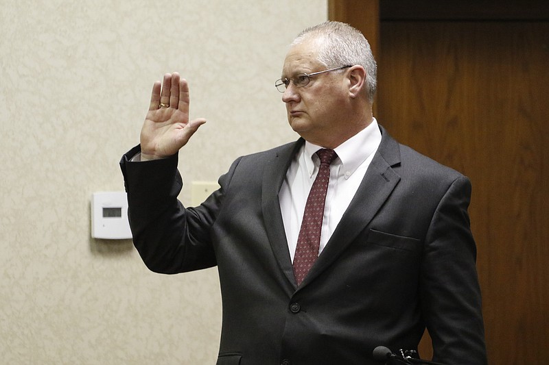 Detective Rodney Burns of the Gatlinburg Police Department is sworn in as a witness before Judge Robert Philyaw during a preliminary hearing for the Ooltewah High School basketball coaches and the school's athletic director in Hamilton County Juvenile Court on Monday.