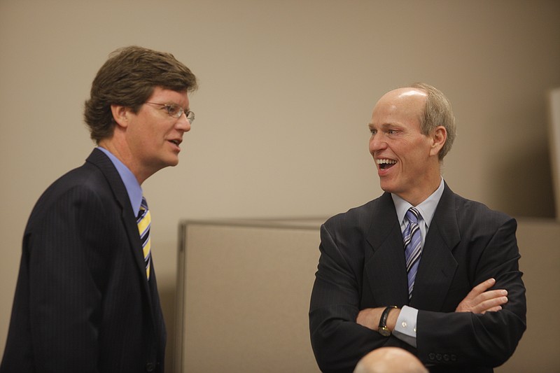 In this file photo, Covenant Transport President Joey Hogan, left, and Chairman David Parker talk during a stockholder meeting.